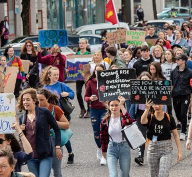 People holding placards with climate change messages on during a climate march
